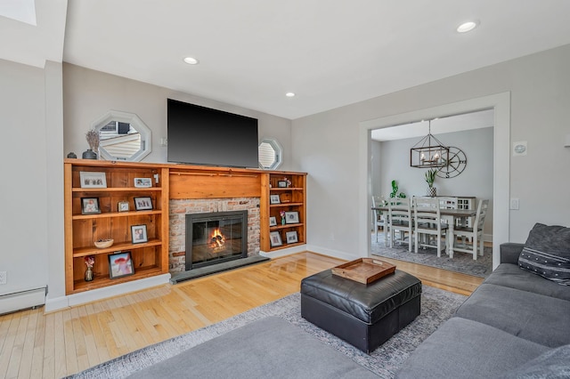 85 Fairmount St, Huntington, NY 11743 - living area featuring a chandelier, wood finished floors, a fireplace, and recessed lighting