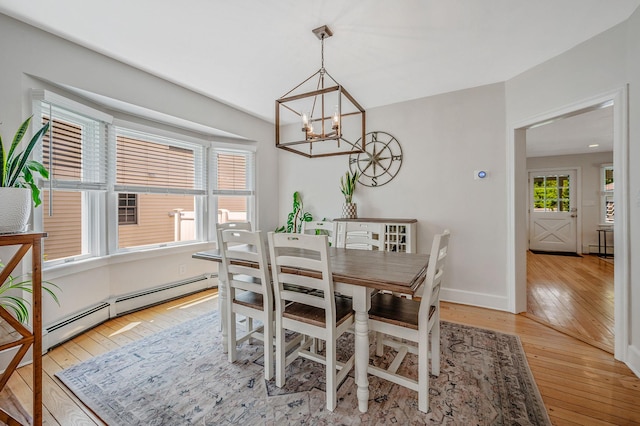 85 Fairmount St, Huntington, NY 11743 - dining area featuring light wood-style floors, a chandelier, a baseboard heating unit, and baseboards