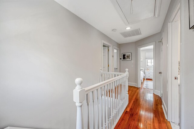 85 Fairmount St, Huntington, NY 11743 - hall with an upstairs landing, attic access, hardwood / wood-style flooring, baseboards, and recessed lighting