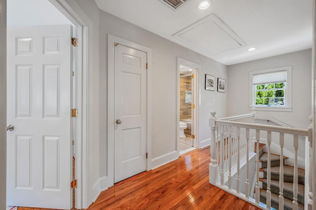 85 Fairmount St, Huntington, NY 11743 - hallway with an upstairs landing, attic access, light wood-type flooring, baseboards, and recessed lighting
