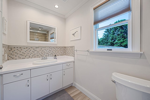 85 Fairmount St, Huntington, NY 11743 - bathroom with toilet, vanity, backsplash, ornamental molding, and wood finished floors