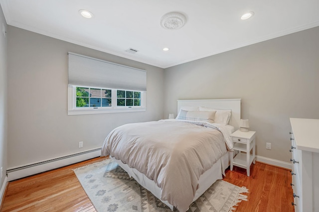 85 Fairmount St, Huntington, NY 11743 - bedroom with baseboard heating, crown molding, light wood-type flooring, recessed lighting, and baseboards
