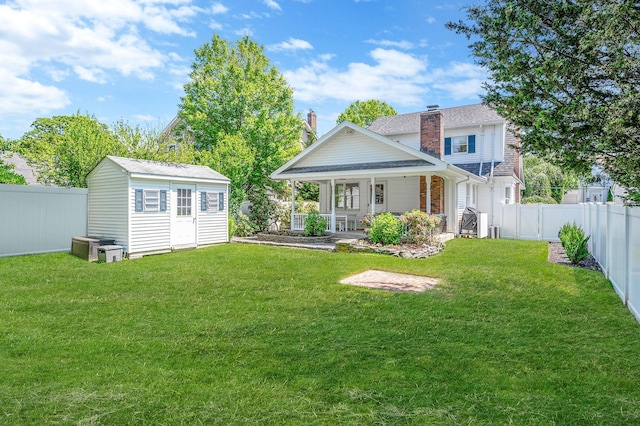 85 Fairmount St, Huntington, NY 11743 - rear view of property with covered porch, an outdoor structure, and a chimney