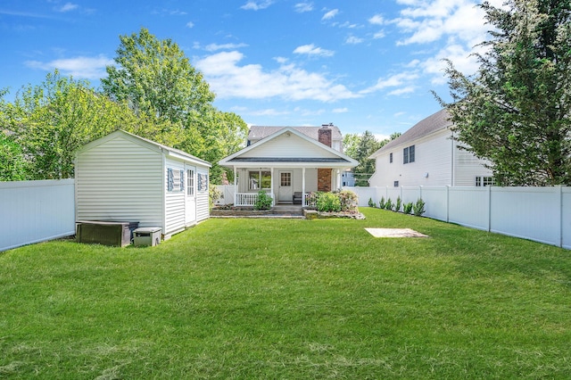 85 Fairmount St, Huntington, NY 11743 - back of property with covered porch, a chimney, and an outdoor structure