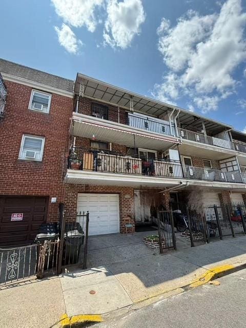 57-54 Xenia St, Corona, NY 11368 - back of house featuring brick siding, a garage, and driveway