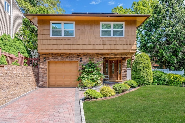 2 Christa Ct, Huntington, NY 11743 - view of front facade with stone siding, a garage, decorative driveway, roof mounted solar panels, and a porch