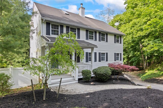 319 Thompson St, Port Jefferson, NY 11777 - view of front of house featuring a chimney and a shingled roof
