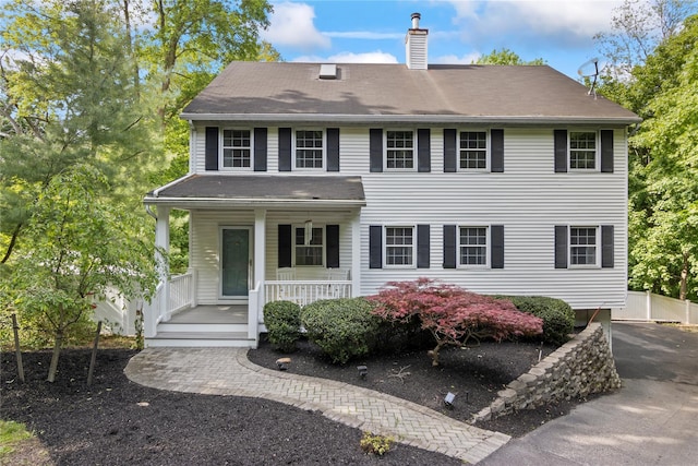 319 Thompson St, Port Jefferson, NY 11777 - view of front of home featuring a chimney and covered porch