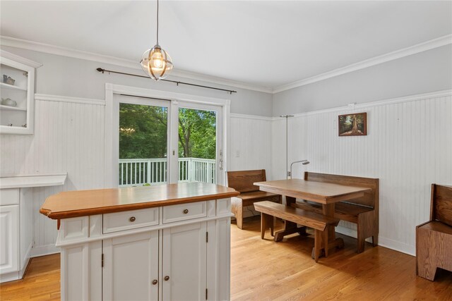 319 Thompson St, Port Jefferson, NY 11777 - dining area featuring light wood-style flooring, wainscoting, and ornamental molding