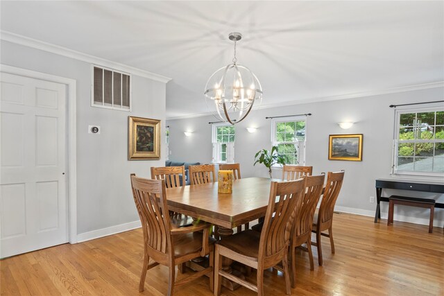 319 Thompson St, Port Jefferson, NY 11777 - dining space with a chandelier, light wood-type flooring, ornamental molding, and baseboards
