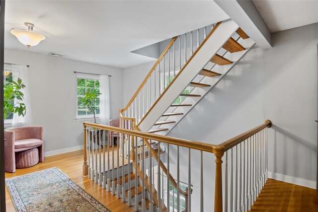 319 Thompson St, Port Jefferson, NY 11777 - staircase with baseboards and wood finished floors