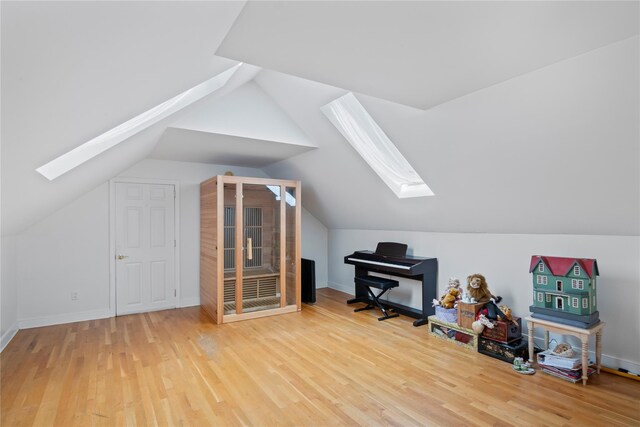 319 Thompson St, Port Jefferson, NY 11777 - additional living space featuring a skylight, wood finished floors, and vaulted ceiling