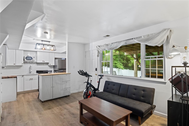 319 Thompson St, Port Jefferson, NY 11777 - living room with light wood-style flooring