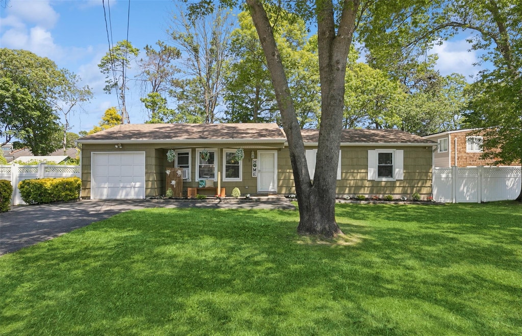 9 Albermarle Ave, Holtsville, NY 11742 - view of front of property with a garage and asphalt driveway