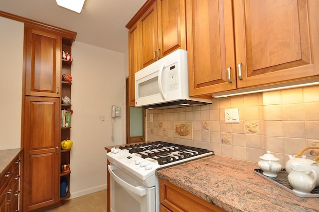 230 Garth Rd Unit 6C1, Scarsdale, NY 10583 - kitchen with white appliances, brown cabinetry, open shelves, decorative backsplash, and light stone counters