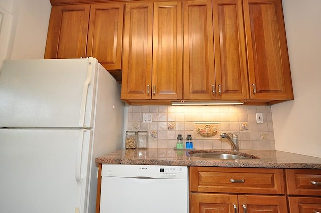 230 Garth Rd Unit 6C1, Scarsdale, NY 10583 - kitchen featuring white appliances, a sink, brown cabinets, tasteful backsplash, and dark stone counters