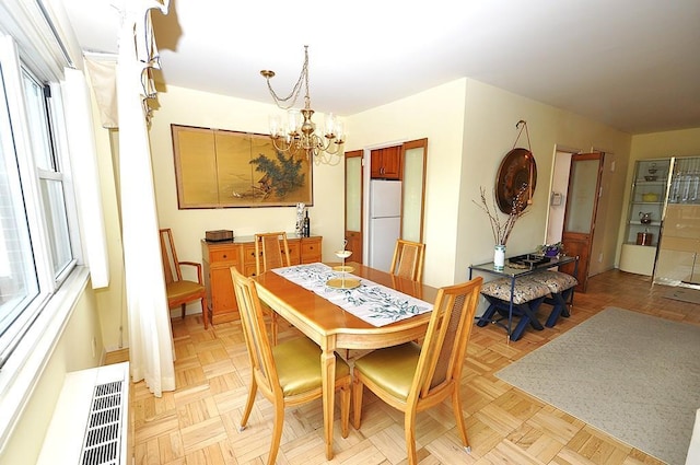 230 Garth Rd Unit 6C1, Scarsdale, NY 10583 - dining space featuring a chandelier