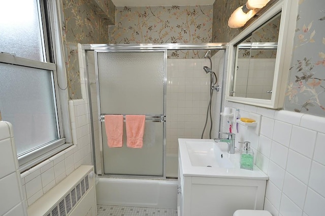230 Garth Rd Unit 6C1, Scarsdale, NY 10583 - full bath with tile walls, bath / shower combo with glass door, wallpapered walls, vanity, and toilet