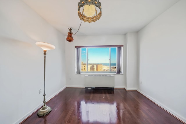 136 Bch 117th St Unit 6H, Rockaway Park, NY 11694 - unfurnished room with radiator heating unit, wood finished floors, and baseboards