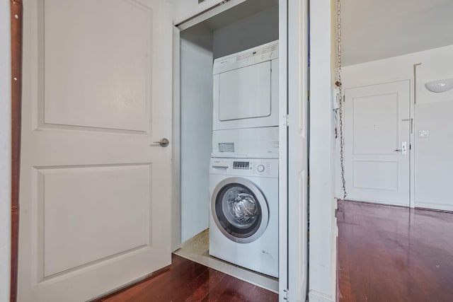 136 Bch 117th St Unit 6H, Rockaway Park, NY 11694 - washroom with estacked washer and dryer and dark wood-type flooring