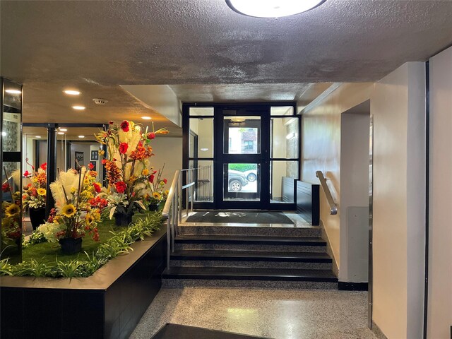 29-09 137th St Unit 1D, Flushing, NY 11354 - building lobby featuring stairway, a textured ceiling, and recessed lighting
