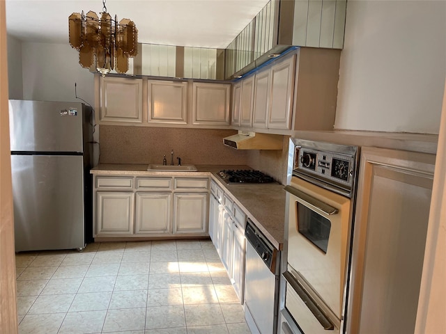 29-09 137th St Unit 1D, Flushing, NY 11354 - kitchen with stainless steel appliances, a sink, light tile patterned floors, a chandelier, and under cabinet range hood