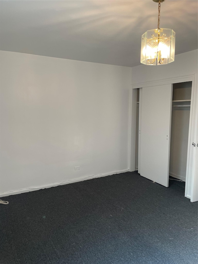 29-09 137th St Unit 1D, Flushing, NY 11354 - unfurnished bedroom with dark colored carpet, a chandelier, and a closet