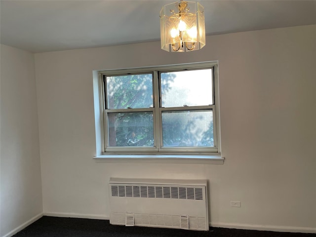 29-09 137th St Unit 1D, Flushing, NY 11354 - carpeted spare room featuring radiator heating unit, a chandelier, and baseboards