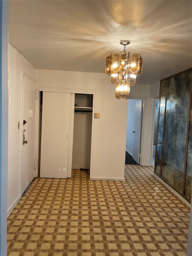29-09 137th St Unit 1D, Flushing, NY 11354 - unfurnished bedroom featuring a chandelier, a closet, and baseboards