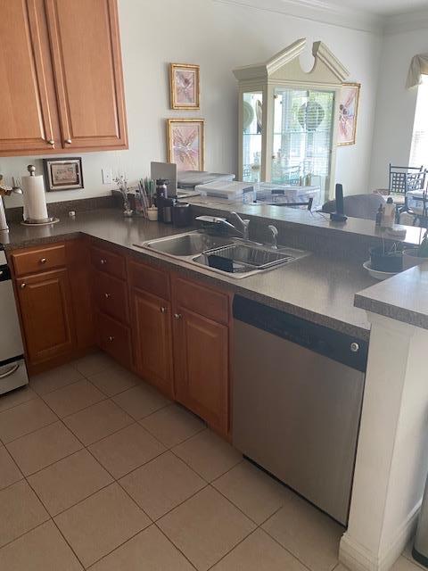 28 Torrey Pine Ln, Bay Shore, NY 11706 - kitchen featuring stainless steel dishwasher, a sink, light tile patterned floors, a peninsula, and crown molding
