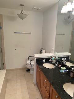 28 Torrey Pine Ln, Bay Shore, NY 11706 - bathroom with a shower stall, toilet, double vanity, and tile patterned flooring