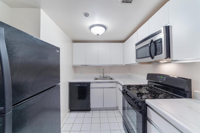 23 Water Grant St Unit 7N, Yonkers, NY 10701 - kitchen with black appliances, a sink, white cabinetry, light tile patterned floors, and light stone counters