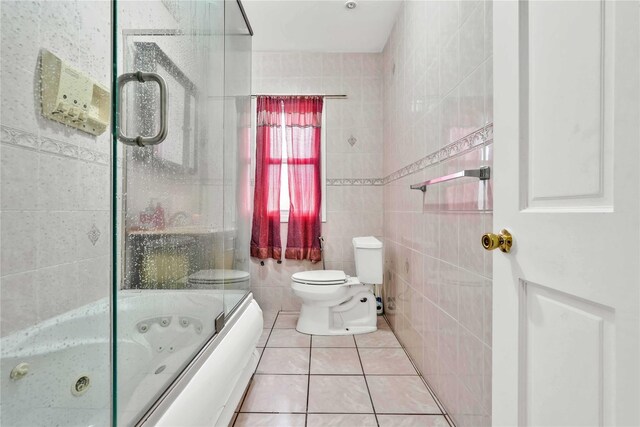 114-11 86th Ave, Richmond Hill North, NY 11418 - bathroom featuring tile walls, toilet, tile patterned floors, and a combined bath / shower with jetted tub