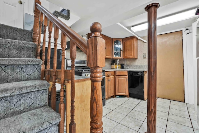 114-11 86th Ave, Richmond Hill North, NY 11418 - kitchen with black dishwasher, stove, light tile patterned flooring, light countertops, and brown cabinets