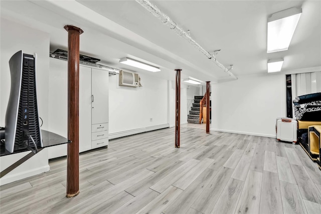 114-11 86th Ave, Richmond Hill North, NY 11418 - finished basement with a baseboard heating unit, light wood-style floors, stairs, and an AC wall unit