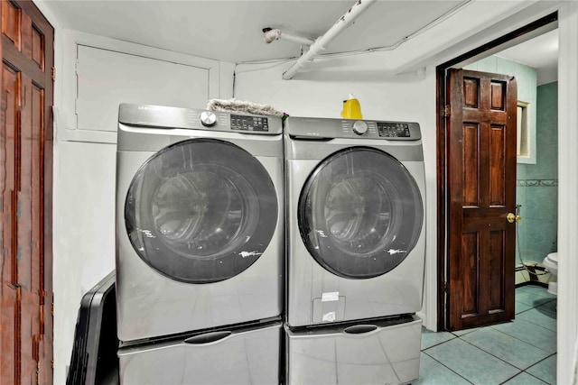 114-11 86th Ave, Richmond Hill North, NY 11418 - laundry room featuring washer and clothes dryer and light tile patterned floors