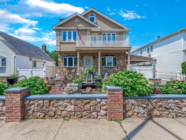 82-44 263rd St, Glen Oaks, NY 11004 - view of front of property featuring a balcony, stone siding, and a porch
