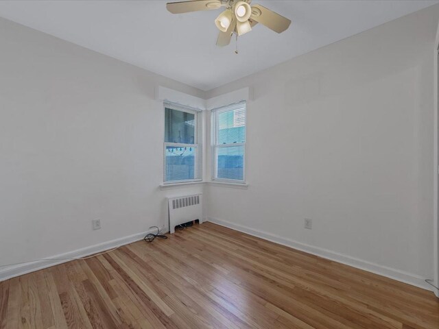 82-44 263rd St, Glen Oaks, NY 11004 - unfurnished room with radiator, light wood-style floors, and ceiling fan