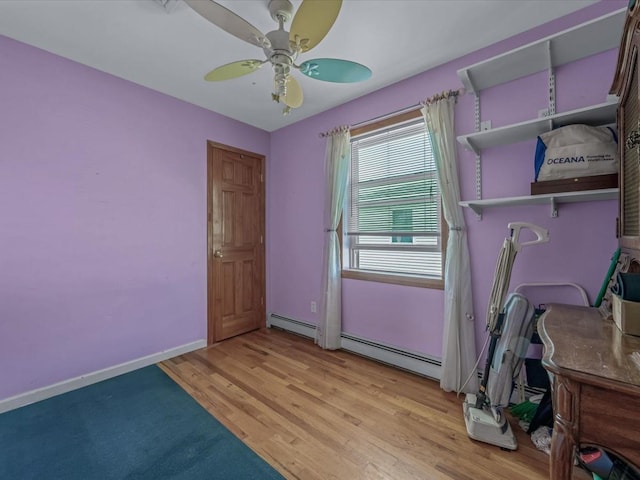 82-44 263rd St, Glen Oaks, NY 11004 - bedroom featuring baseboard heating, light wood-style floors, and ceiling fan