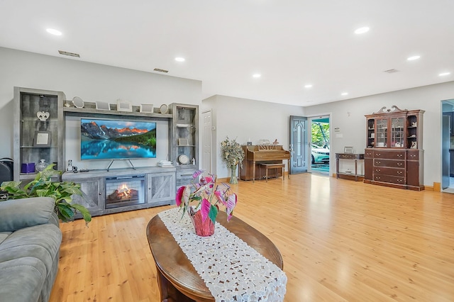 1340 Stony Brook Rd, Stony Brook, NY 11790 - living area with light wood finished floors, a glass covered fireplace, and recessed lighting