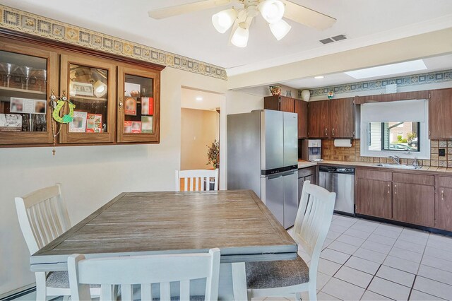 1340 Stony Brook Rd, Stony Brook, NY 11790 - dining area with light tile patterned flooring, ceiling fan, and a baseboard heating unit