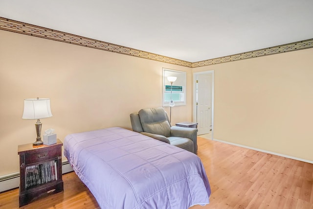 1340 Stony Brook Rd, Stony Brook, NY 11790 - bedroom with wood finished floors and a baseboard radiator