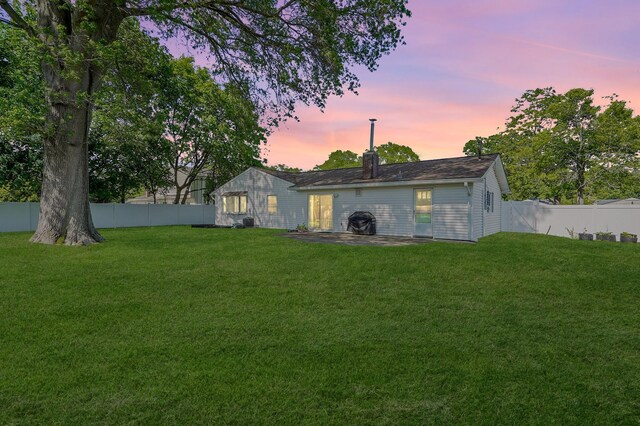 1340 Stony Brook Rd, Stony Brook, NY 11790 - back of house at dusk with a fenced backyard and a chimney