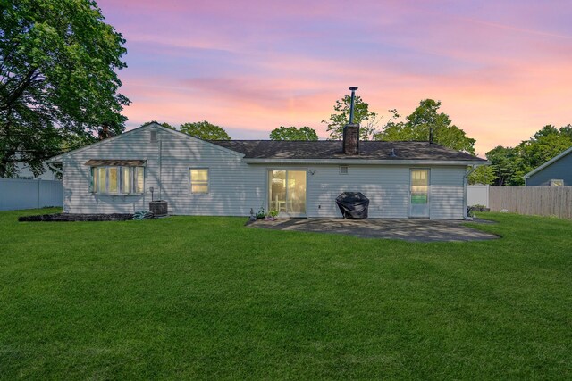 1340 Stony Brook Rd, Stony Brook, NY 11790 - back of house at dusk featuring a patio and a chimney