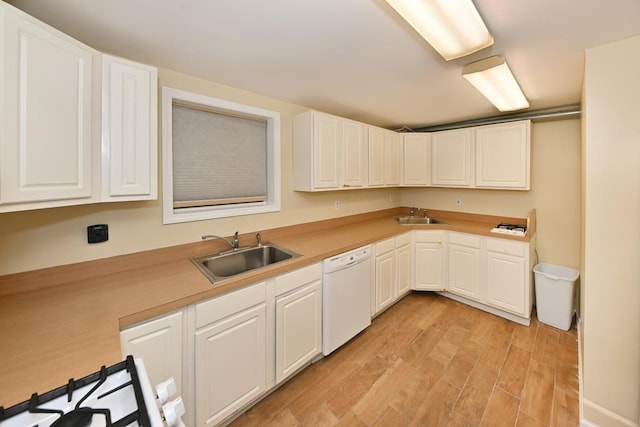 2 Elener Ln, Spring Valley, NY 10977 - kitchen featuring dishwasher, a sink, light wood-type flooring, and white cabinetry