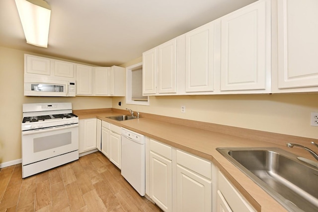 2 Elener Ln, Spring Valley, NY 10977 - kitchen with white appliances, a sink, light wood-style floors, and white cabinets