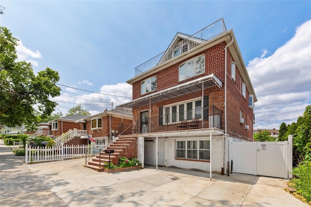 628 151st St, Whitestone, NY 11357 - american foursquare style home with brick siding, a gate, and stairs