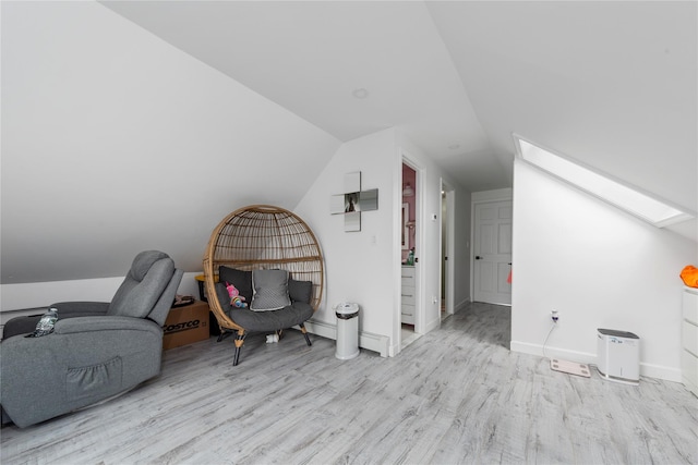 628 151st St, Whitestone, NY 11357 - additional living space with a skylight, wood finished floors, vaulted ceiling, and baseboards
