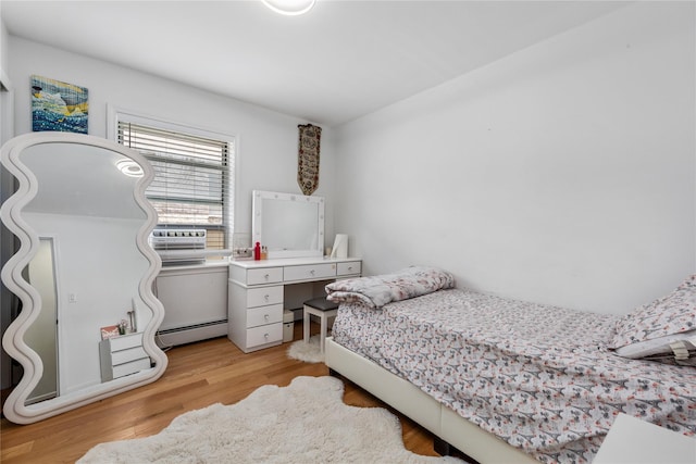 628 151st St, Whitestone, NY 11357 - bedroom featuring a baseboard radiator, light wood-style floors, and cooling unit