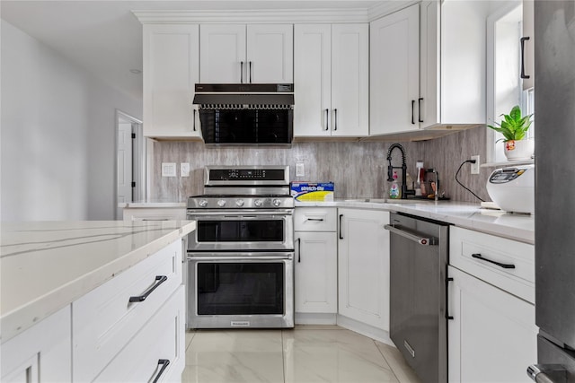 628 151st St, Whitestone, NY 11357 - kitchen featuring stainless steel appliances, a sink, light marble finish floors, backsplash, and white cabinets